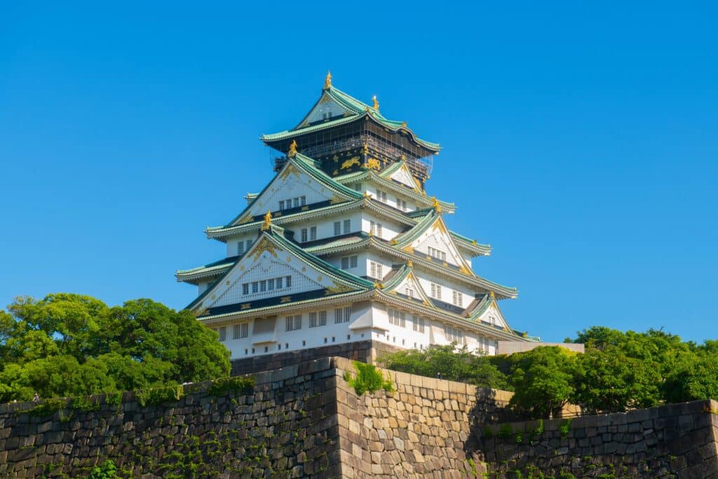Osaka Castle main tower with blue sky and traditional architecture details