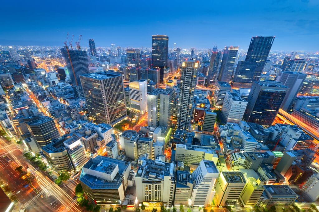Osaka skyline at night with illuminated buildings and busy city streets