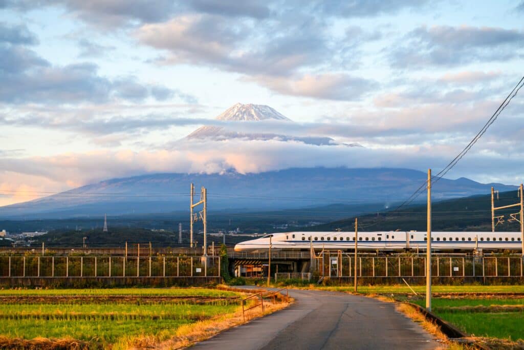 Shinkansen bullet train passing Mount Fuji in Japan