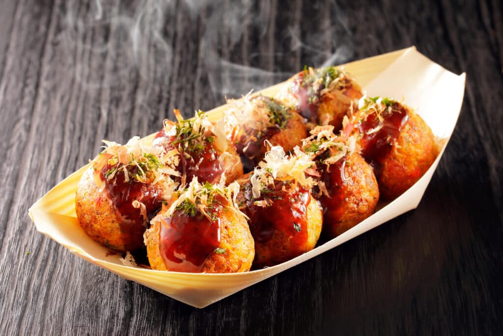 Takoyaki octopus balls with sauce and bonito flakes