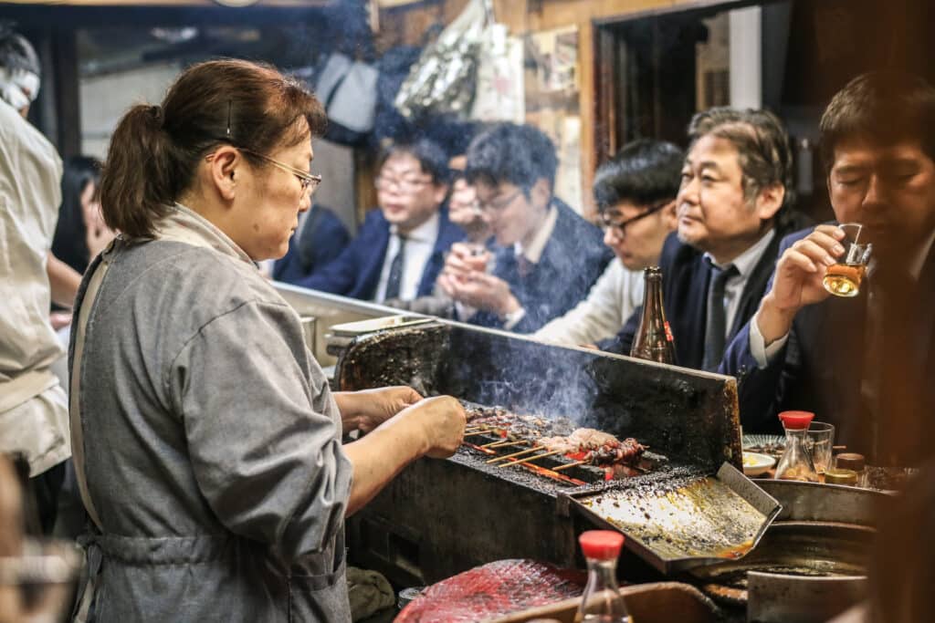 Japanese izakaya in Tokyo with grilled skewers and locals dining