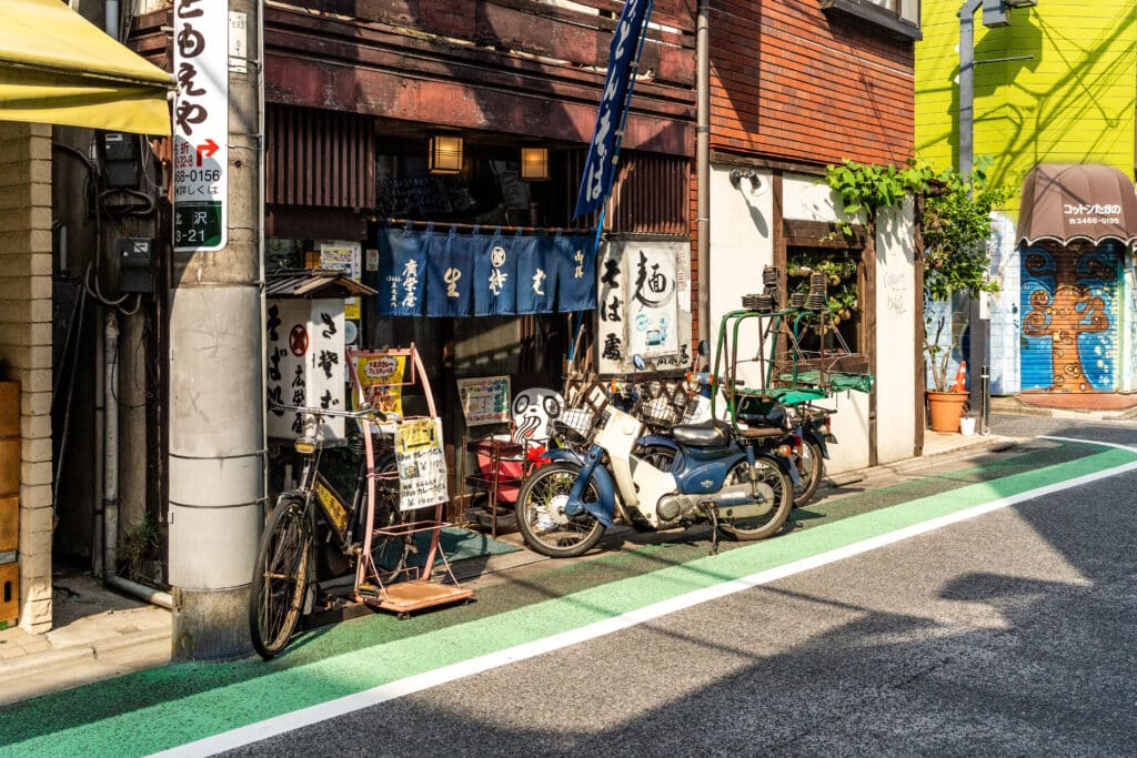 Local street in Tokyo with small shops, bicycles, and traditional storefronts