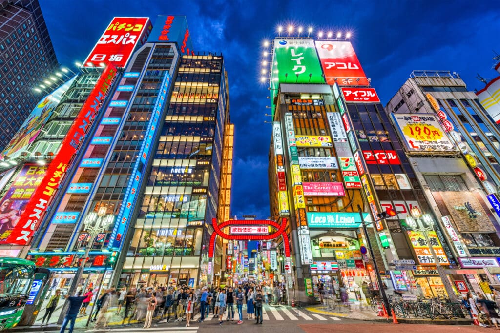 Shinjuku nightlife street with neon lights and crowds