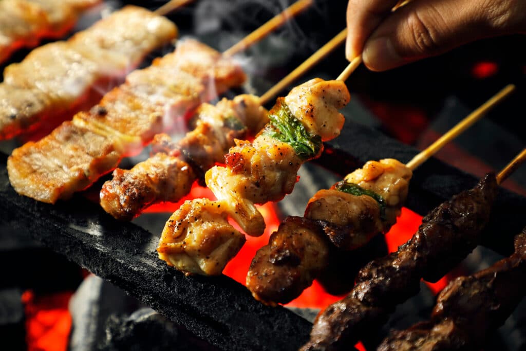 Yakitori grilled chicken skewers over charcoal grill