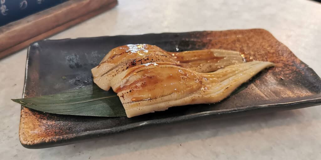 Anago sushi (grilled conger eel) served on a traditional plate in Miyajima, Japan
