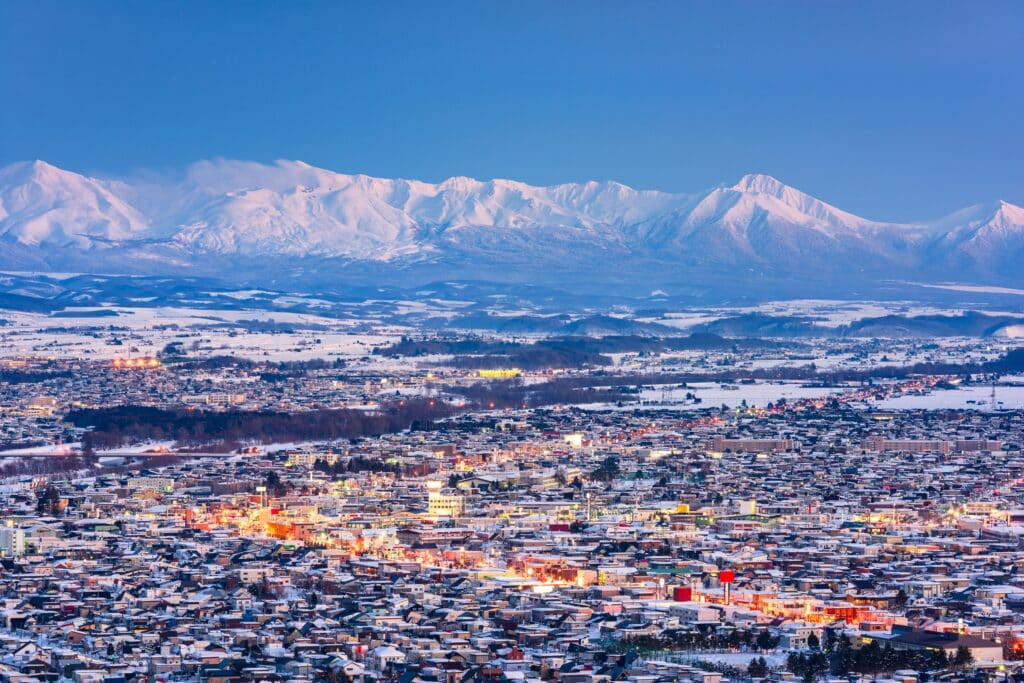 Winter cityscape of Asahikawa with snowy mountains in Hokkaido