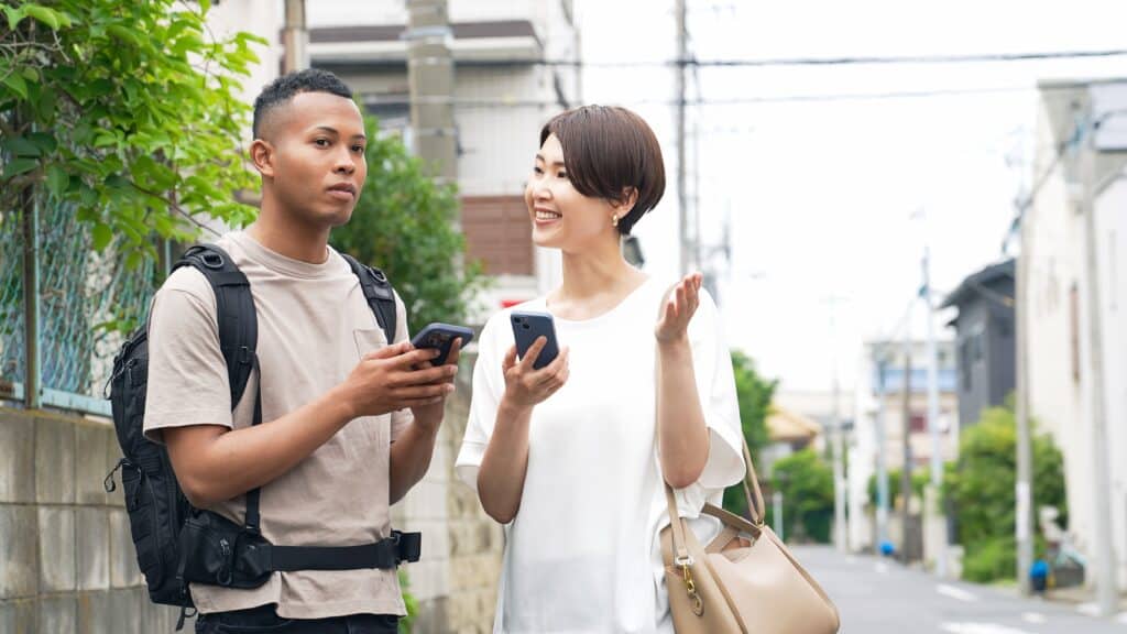 Traveler asking a local resident for directions in a Japanese neighborhood