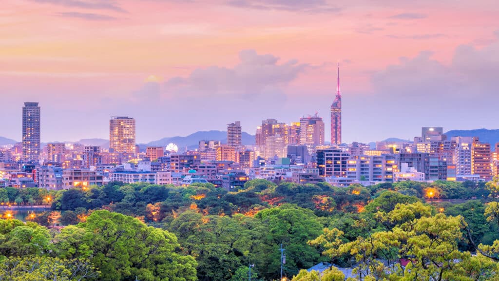 Fukuoka skyline at sunset with city buildings and green park landscape