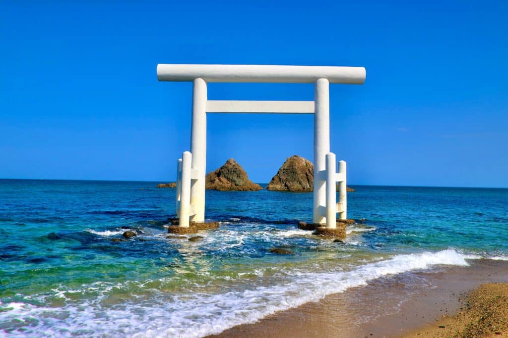 Futamigaura beach torii gate and Meoto Iwa rocks in the ocean Japan