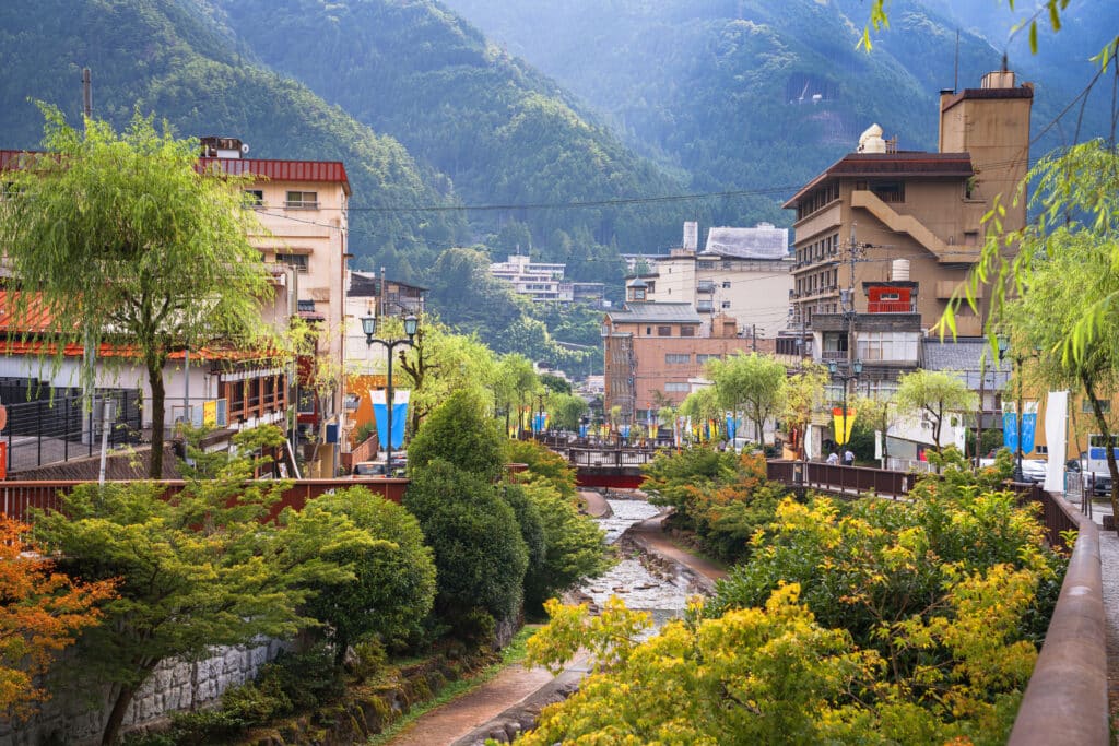 Riverside view of Gero Onsen surrounded by mountains in Japan