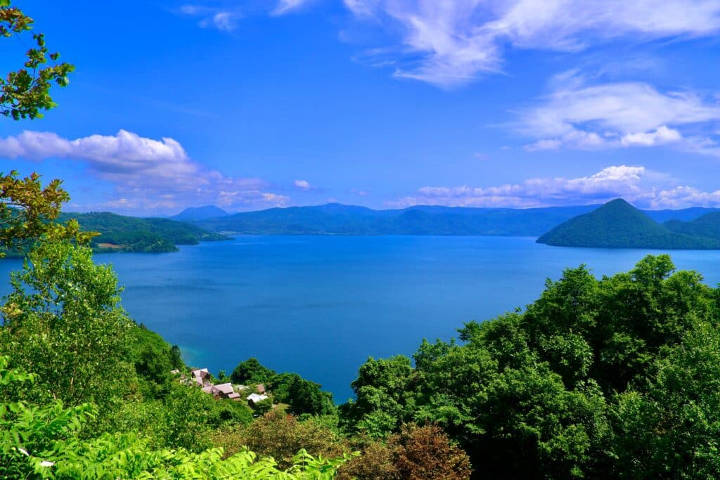 Scenic panoramic view over Lake Toya in Hokkaido surrounded by mountains and forest