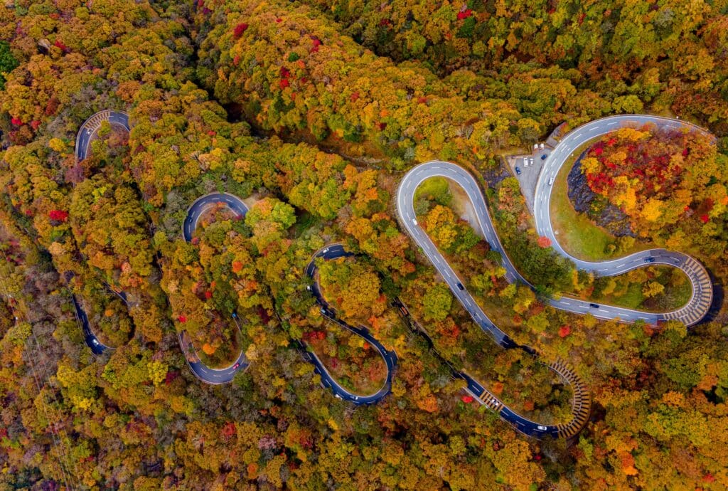 Winding Irohazaka Road through colorful autumn forests in Nikko