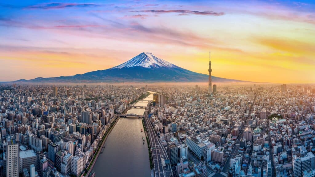 Tokyo skyline at sunset with Mount Fuji visible in the distance