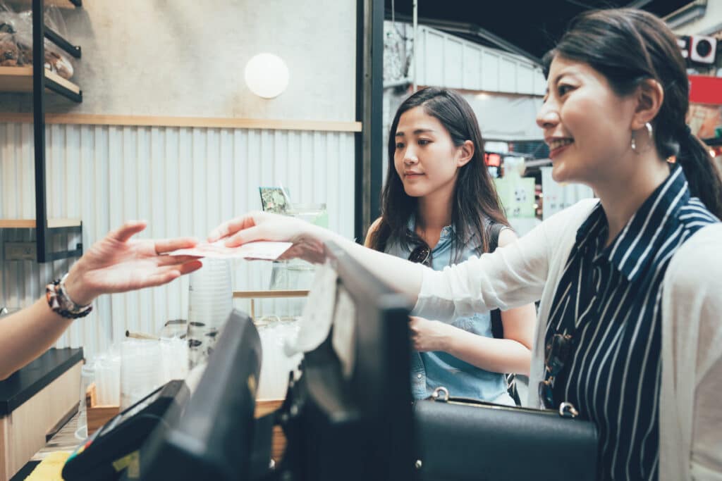 Customer paying with Japanese yen at a small shop in Japan