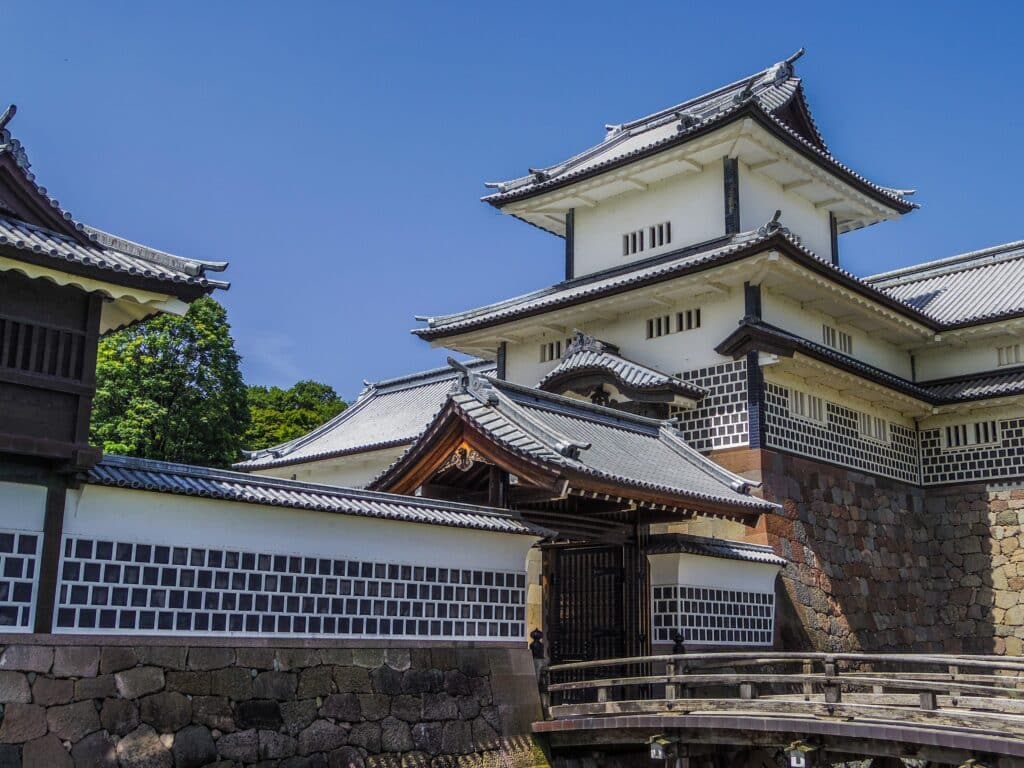 Kanazawa Castle main gate and white castle tower under blue sky