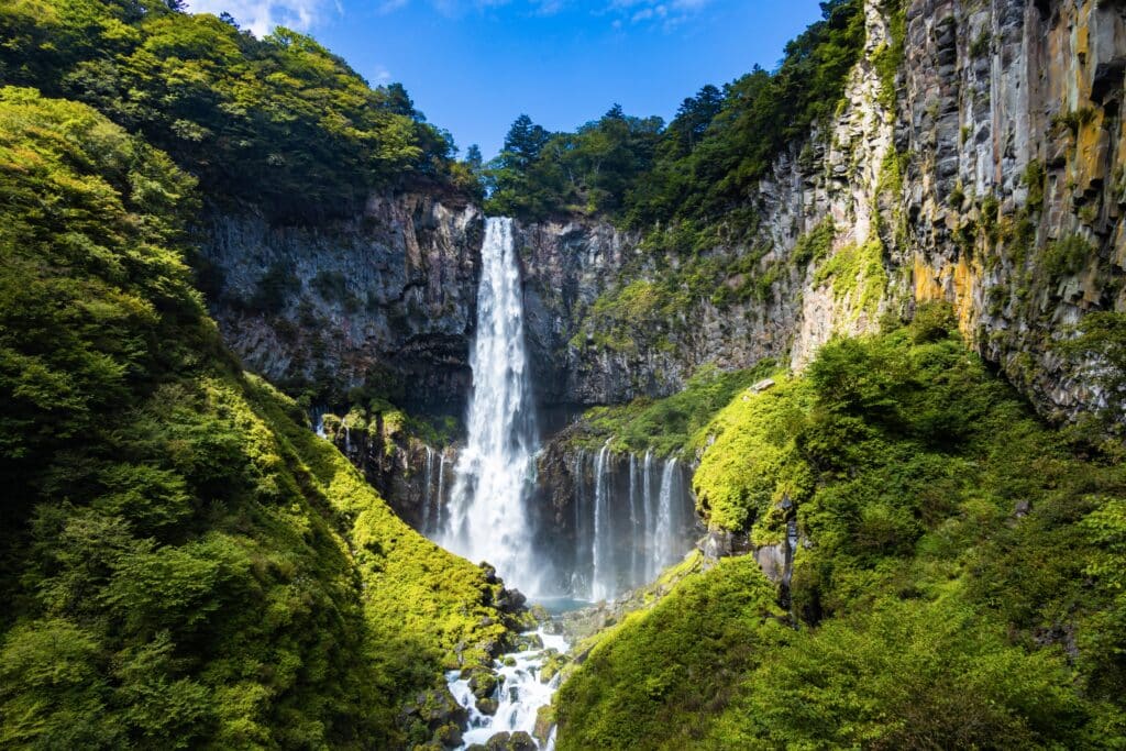 Kegon Falls surrounded by green cliffs in Nikko
