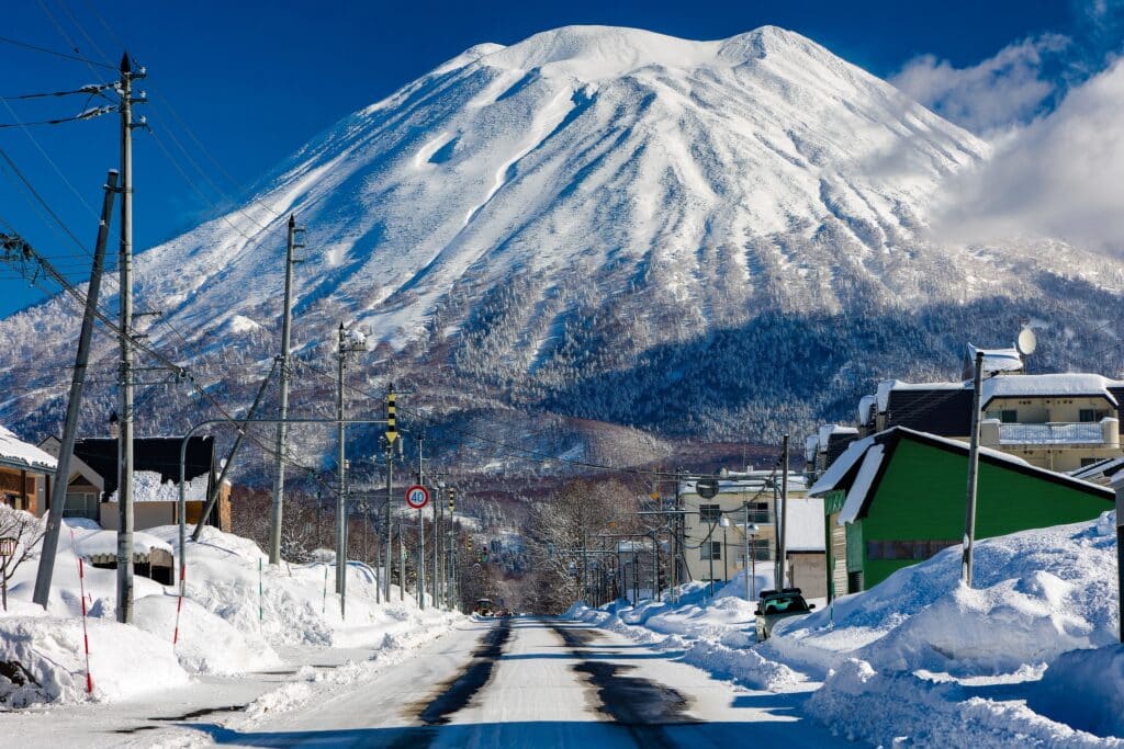 Snow-covered road and Mount Yotei in Niseko during winter in Hokkaido