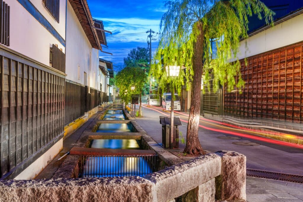 Traditional Takayama street illuminated at night with willow trees