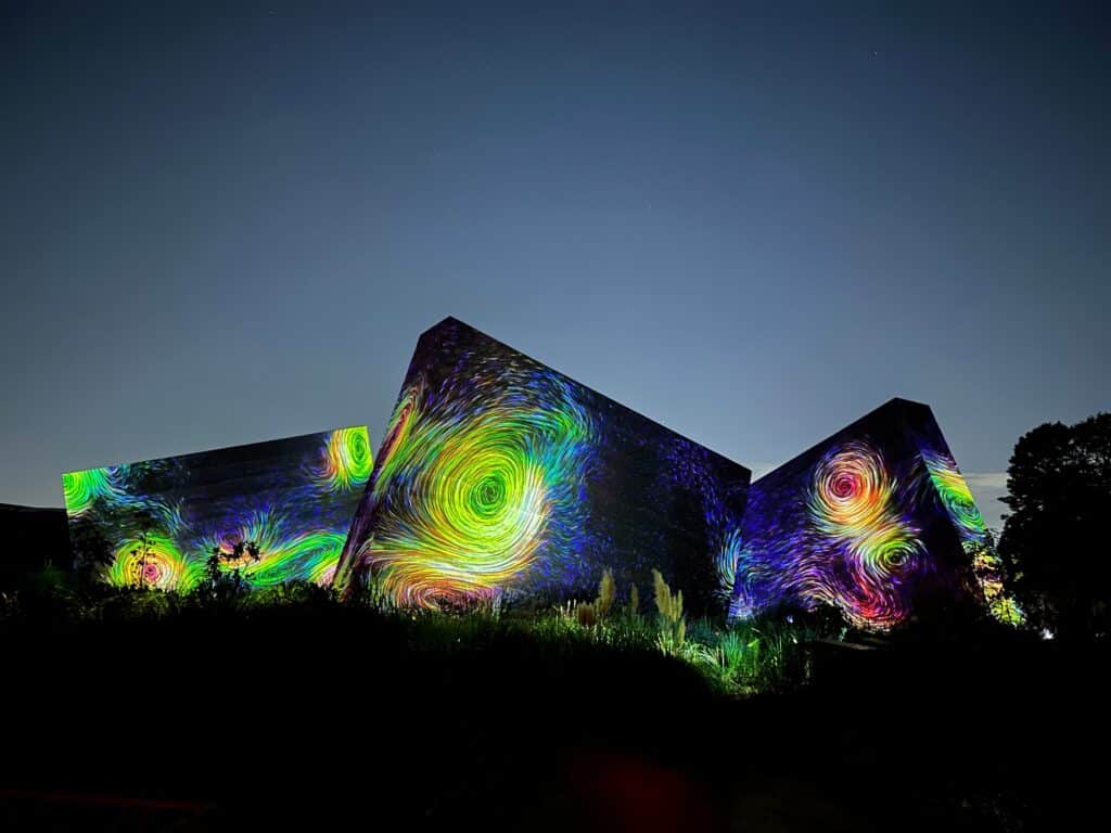 Colorful digital art installation at night with swirling light projections in Japan