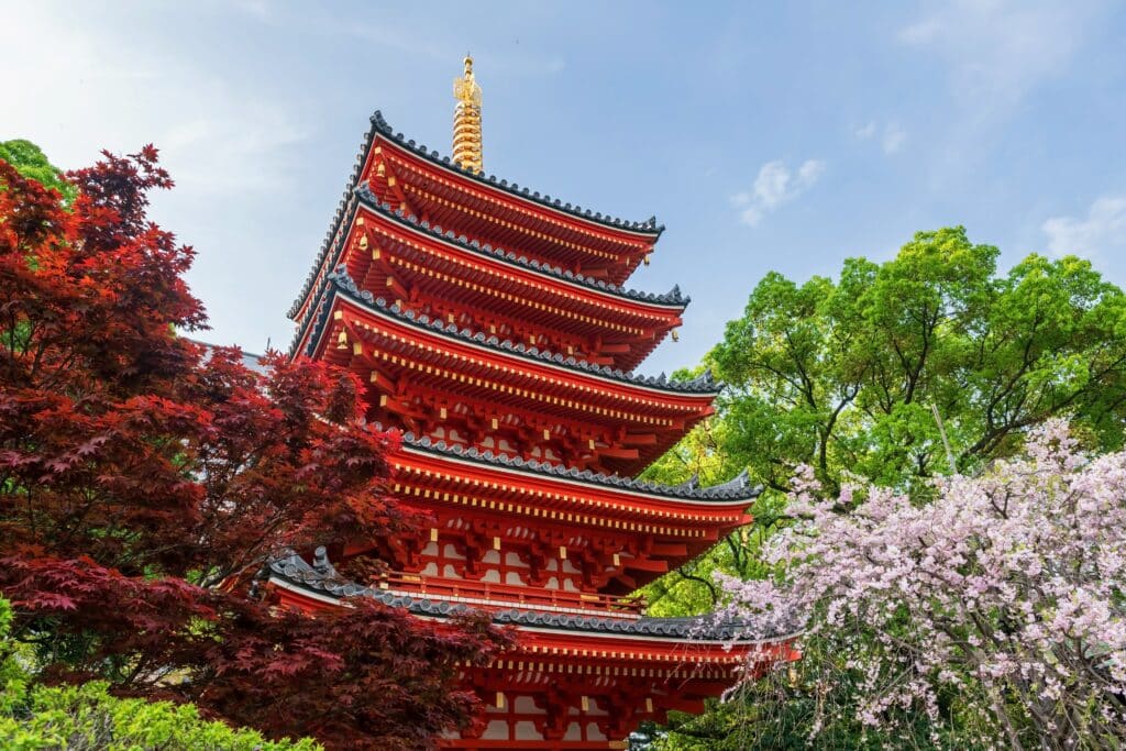 Traditional pagoda at Tocho-ji Temple in Fukuoka surrounded by seasonal trees