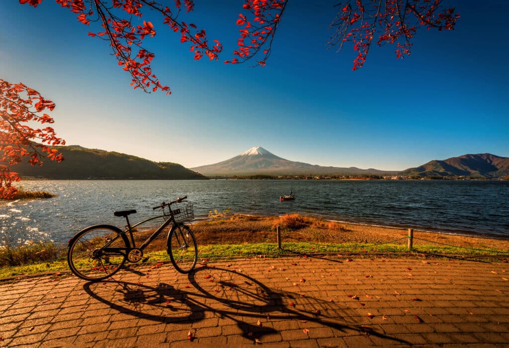Bicycle parked beside Lake Kawaguchiko with Mount Fuji in the background