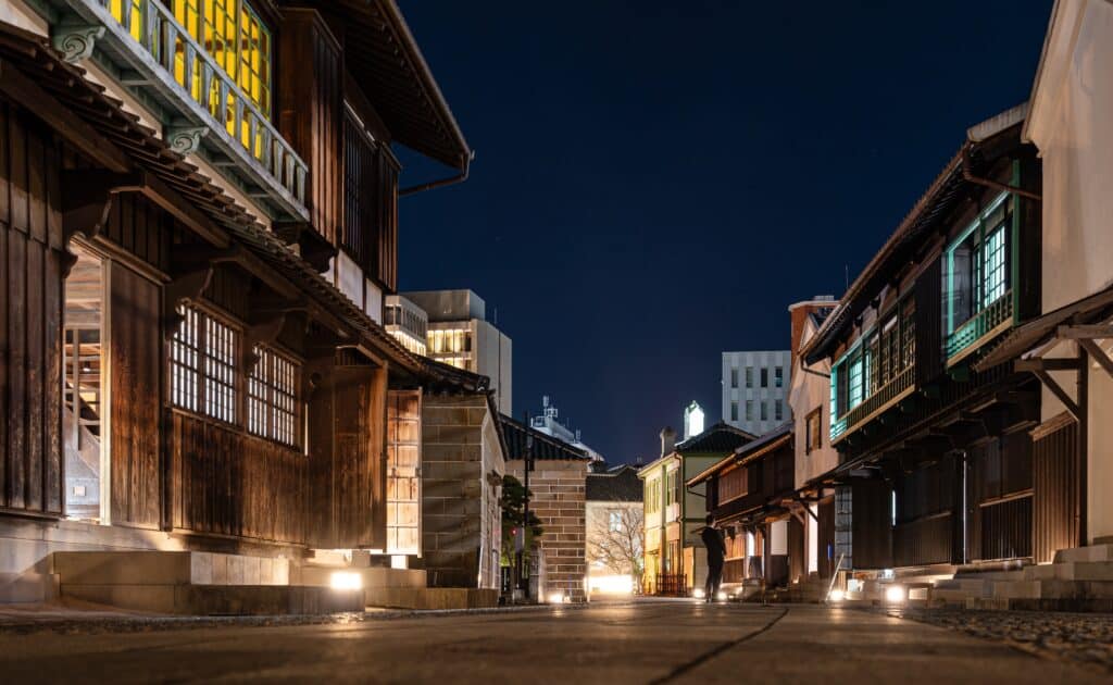 Traditional buildings illuminated at night in the historic Dejima district of Nagasaki