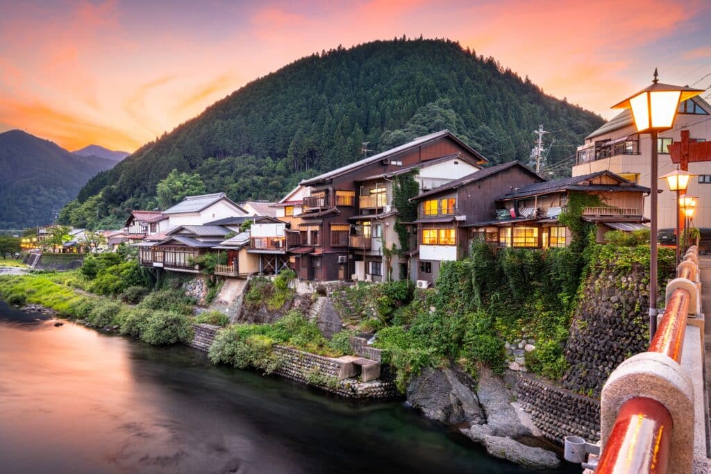 Traditional riverside houses in Gujo Hachiman illuminated at sunset in the mountains of Gifu Prefecture