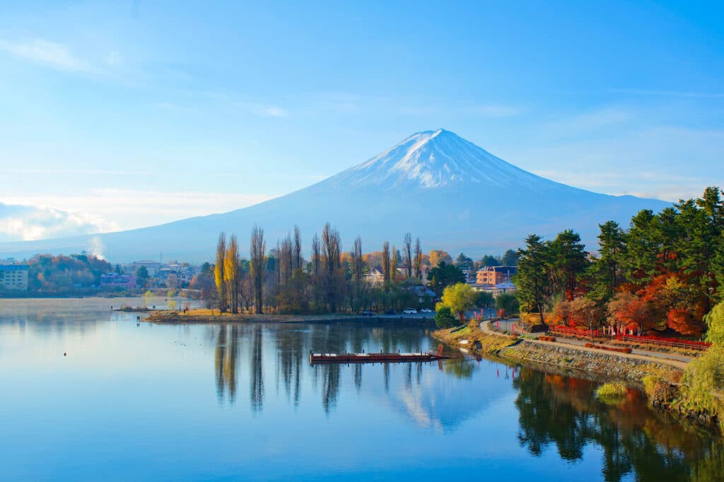 Mount Fuji reflected in the calm waters of Lake Kawaguchi on a clear day