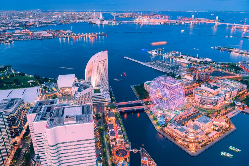 Aerial night view of Minato Mirai featuring Cosmo Clock 21 Ferris wheel and Yokohama Bay