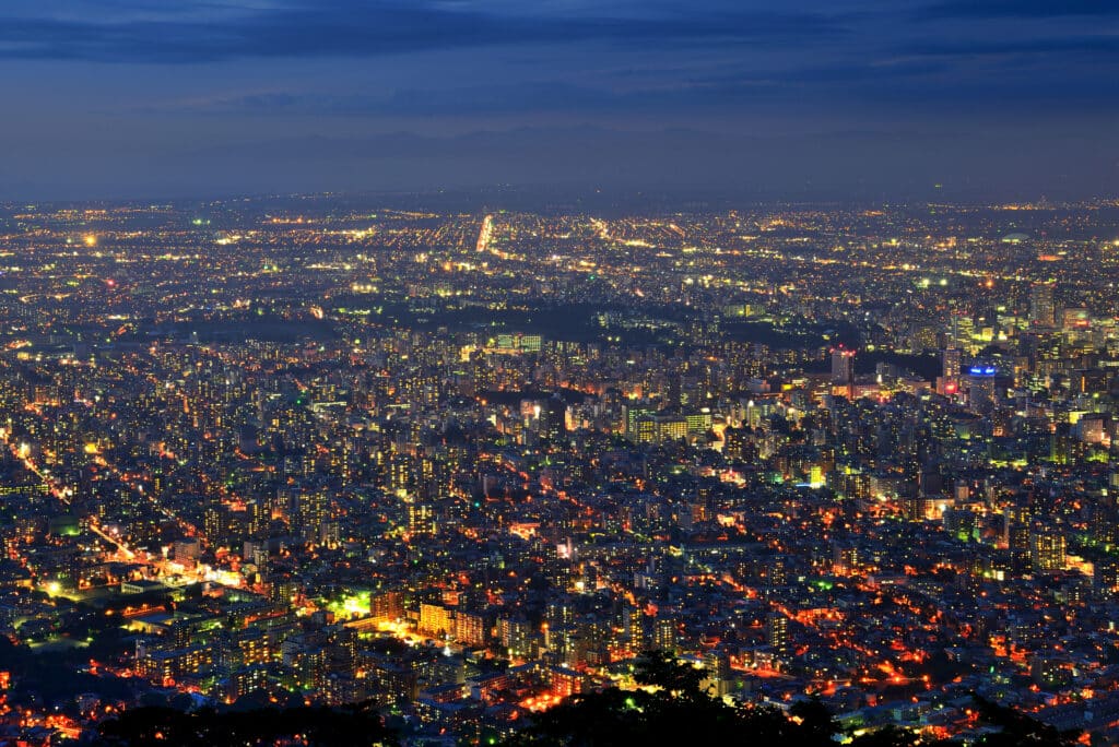 Panoramic nighttime view of Sapporo illuminated by city lights from Mt. Moiwa