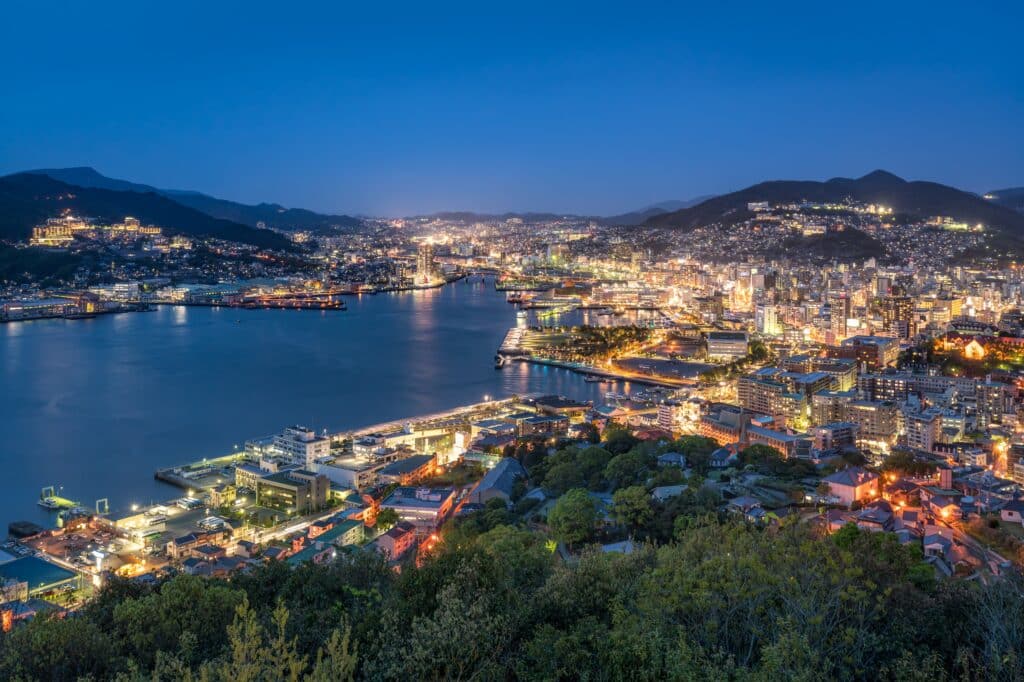 Night view of Nagasaki Harbor and city lights seen from a hillside viewpoint