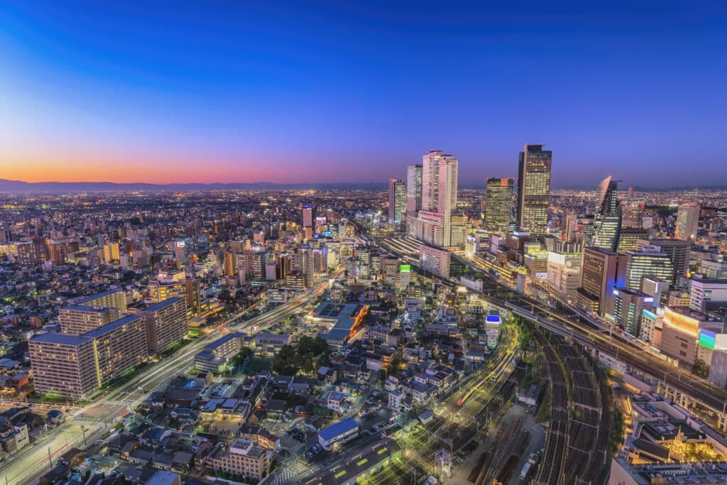 Aerial view of Nagoya Station and the surrounding city skyline illuminated at dusk
