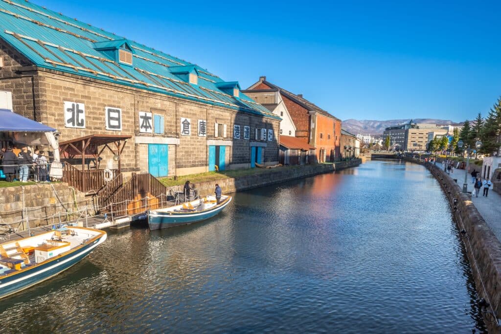 Historic warehouses and canal waterfront in Otaru on a sunny day