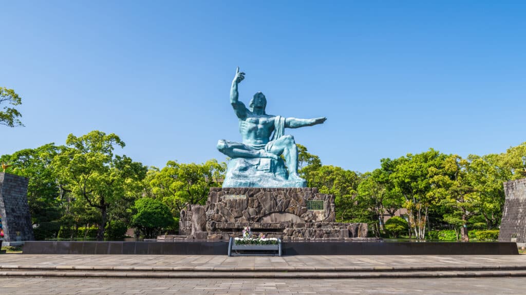 Peace Statue in Nagasaki Peace Park surrounded by trees and open space