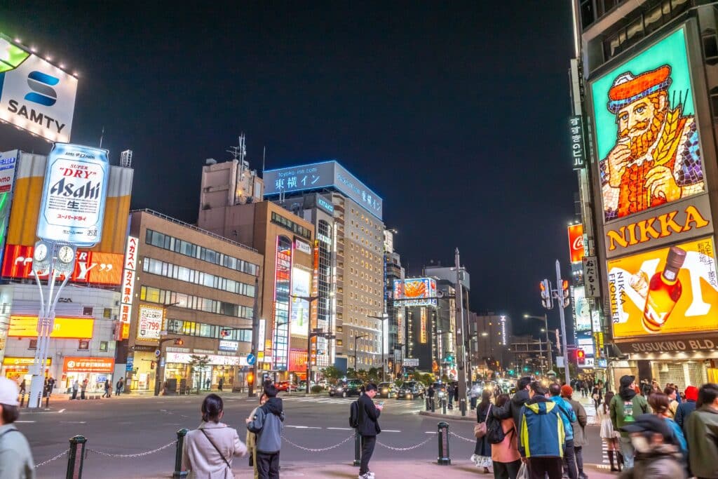 Crowds walking through the illuminated Susukino entertainment district in Sapporo at night