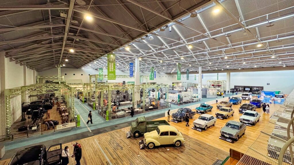 Historic and classic vehicles displayed inside the Toyota Automobile Museum near Nagoya