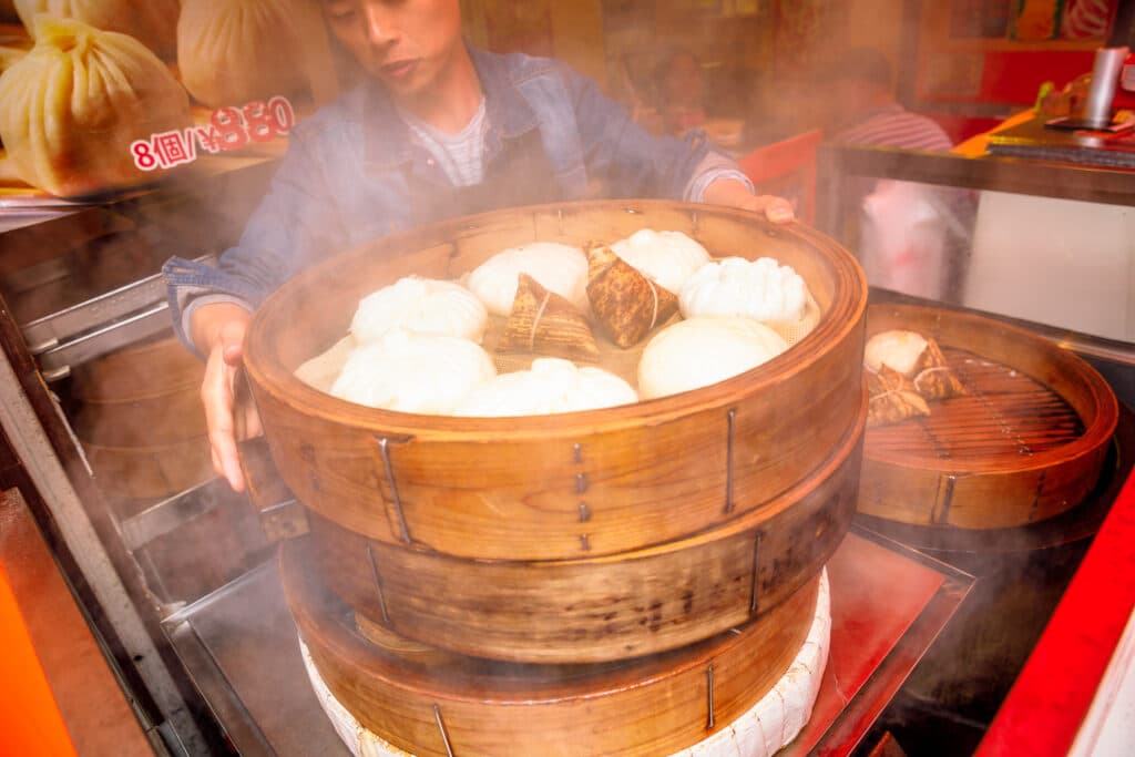 Traditional dim sum served in a bamboo steamer in Yokohama Chinatown