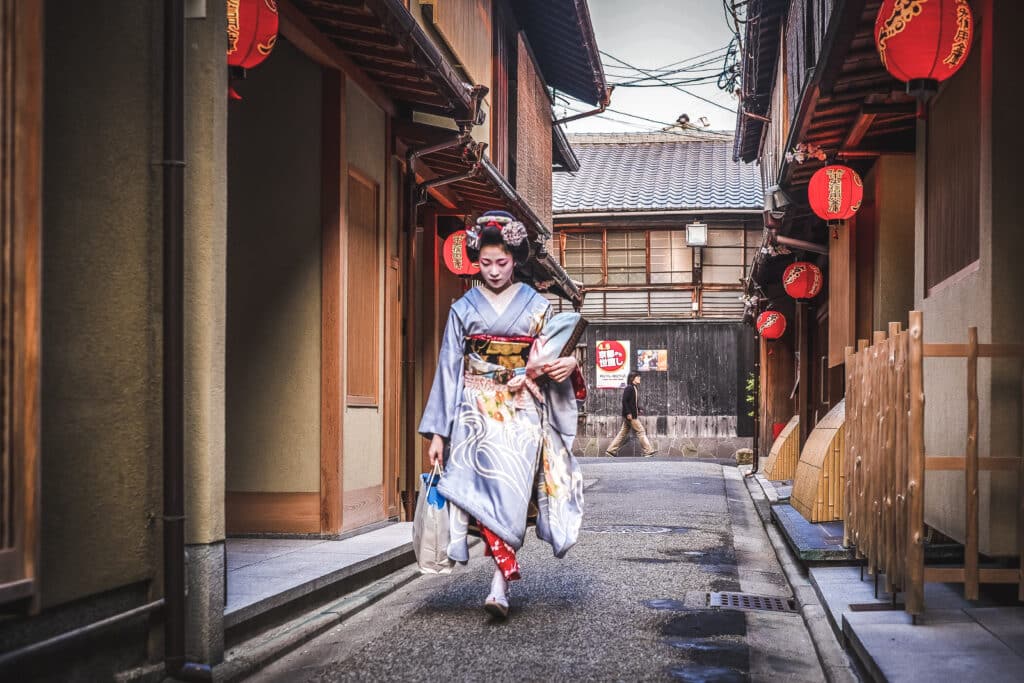 A geisha walking through Kyoto's historic Gion district