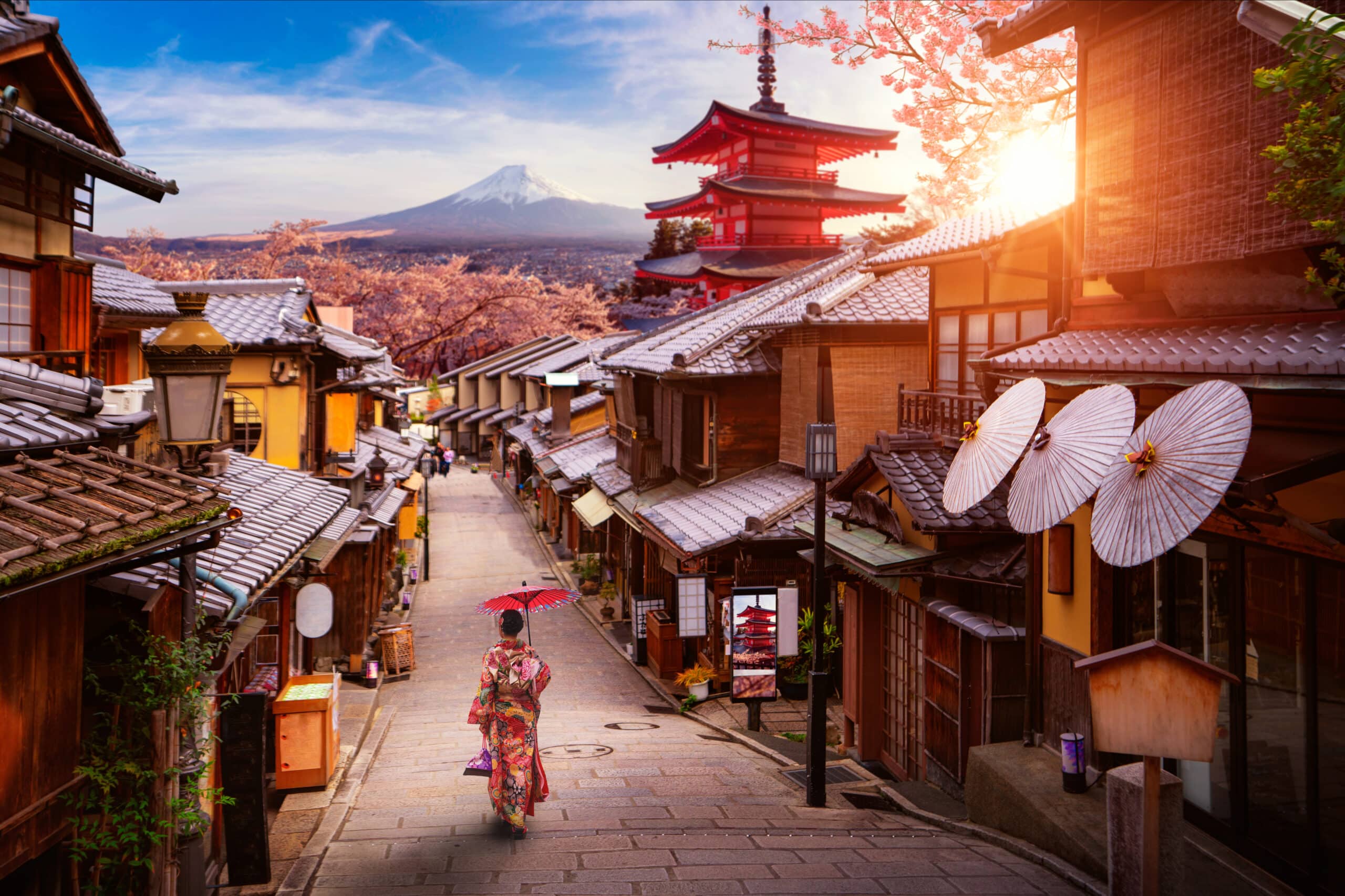 Historic Higashiyama street in Kyoto with traditional houses and Mount Fuji in the distance