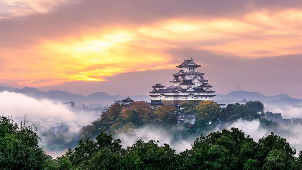 Himeji Castle rising above morning mist at sunrise in Hyogo Prefecture, Japan
