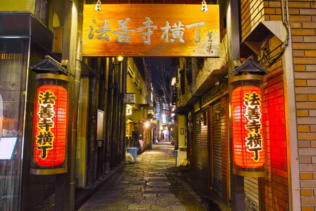 Lantern-lit entrance to Hozenji Yokocho alley in Osaka at night