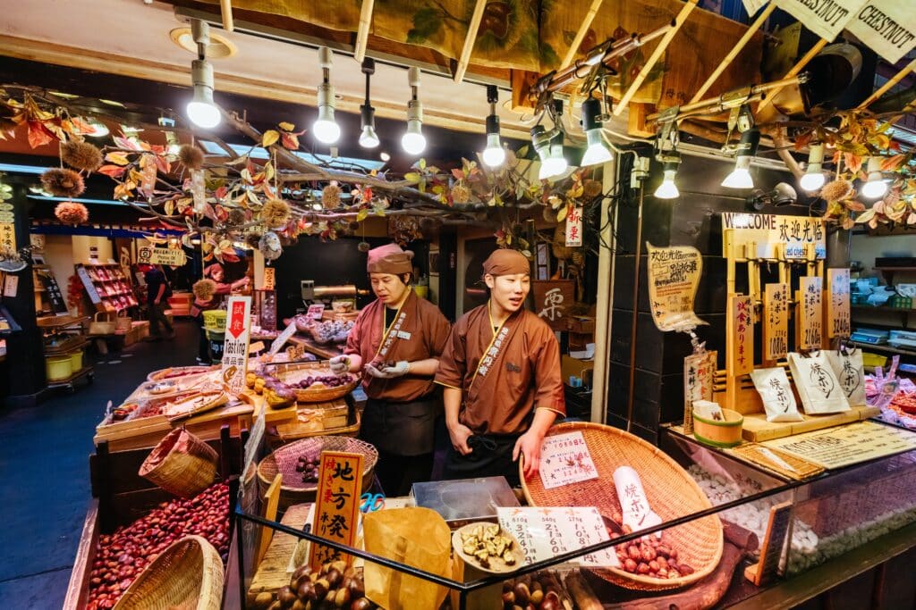 Vendor selling roasted chestnuts and local specialties at Nishiki Market in Kyoto