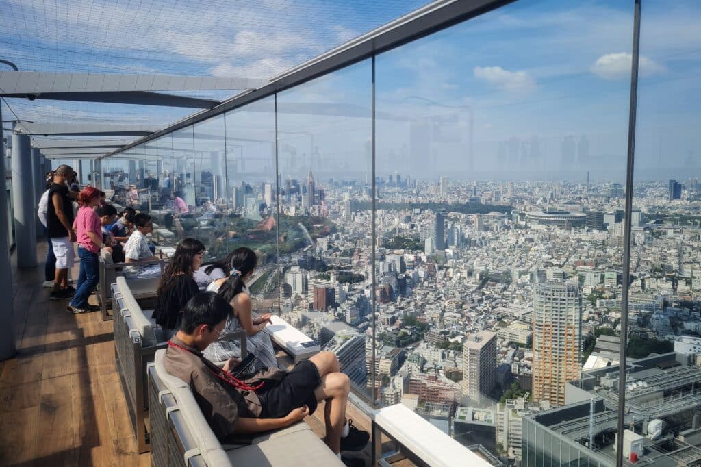 Visitors enjoying panoramic city views from the Shibuya Sky observation deck