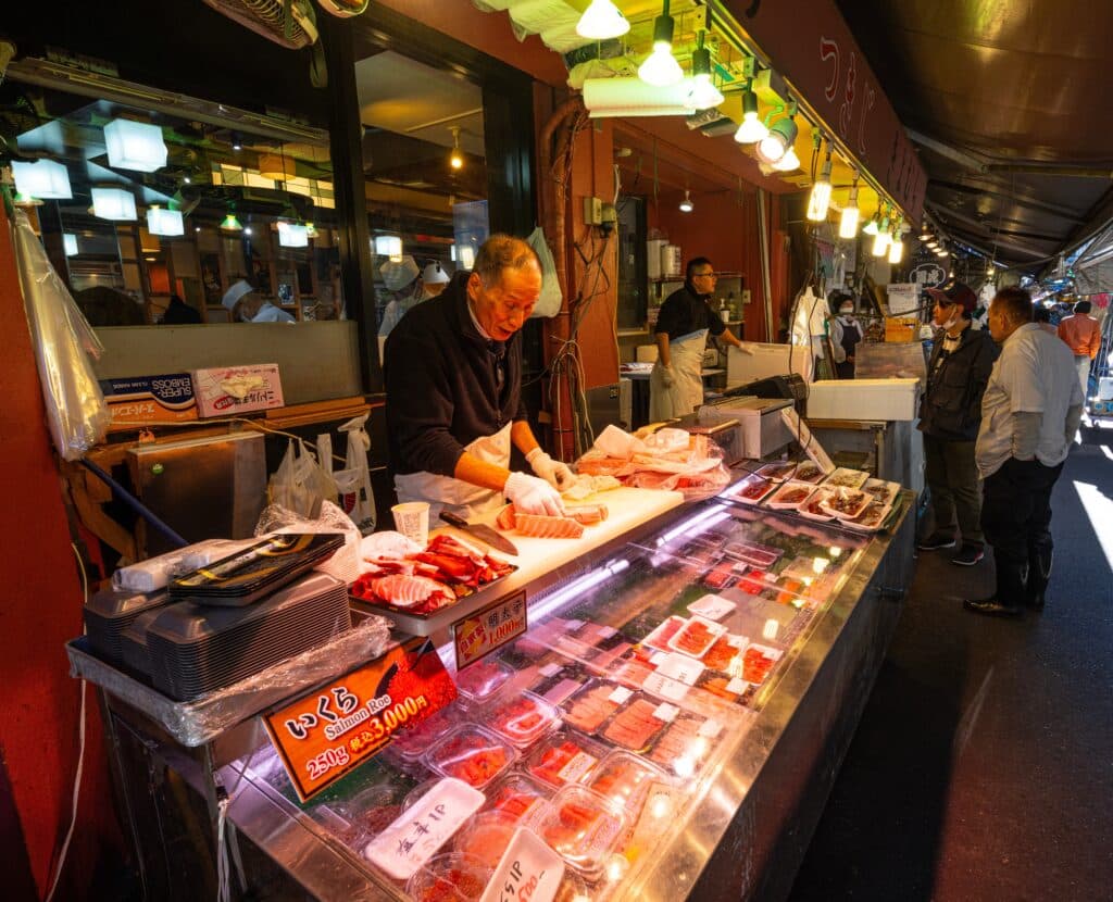 Seafood vendor preparing fresh tuna at Tsukiji Outer Market