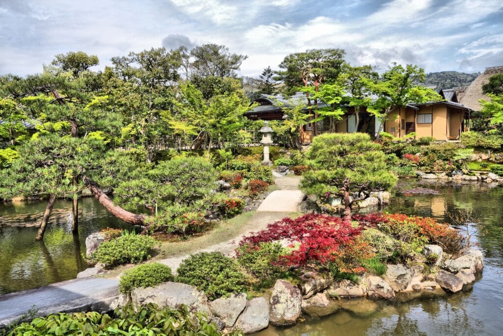 Peaceful landscape of Yoshikien Garden featuring ponds, stone paths, and traditional Japanese architecture