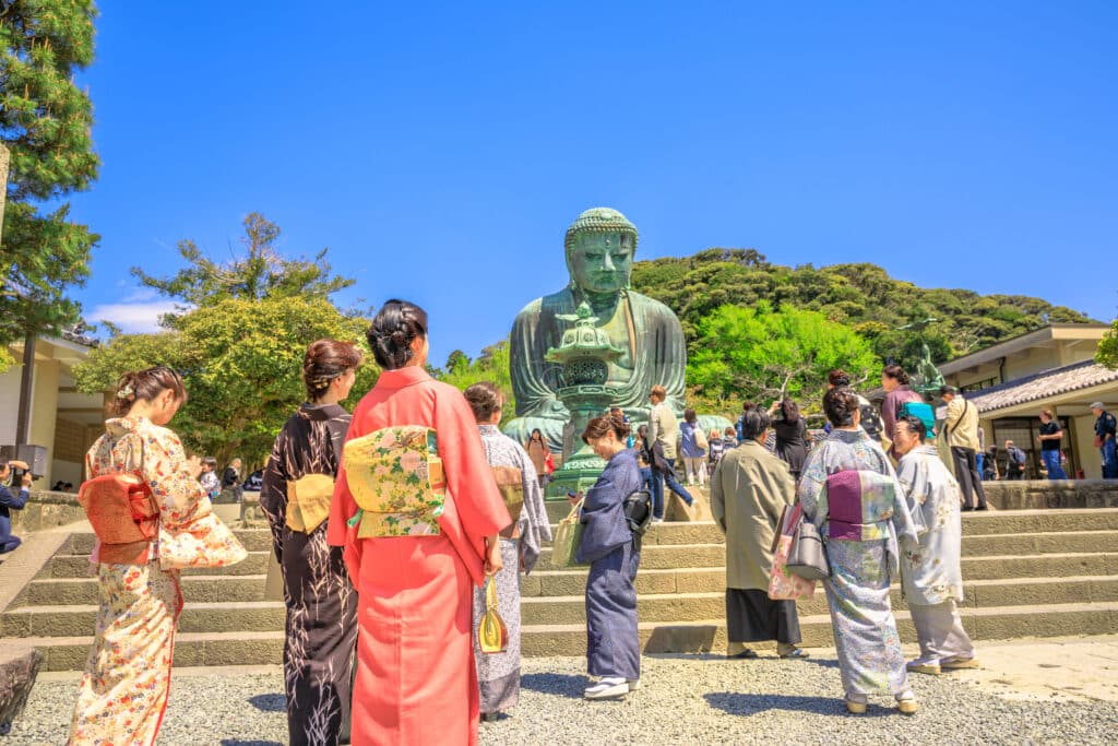Visitors in front of the Great Buddha of Kamakura at Kotoku-in Temple