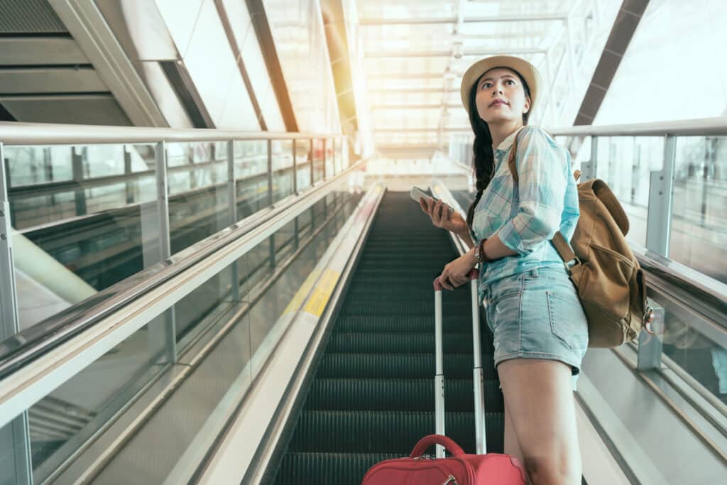 Traveler with a suitcase and backpack at a train station in Japan