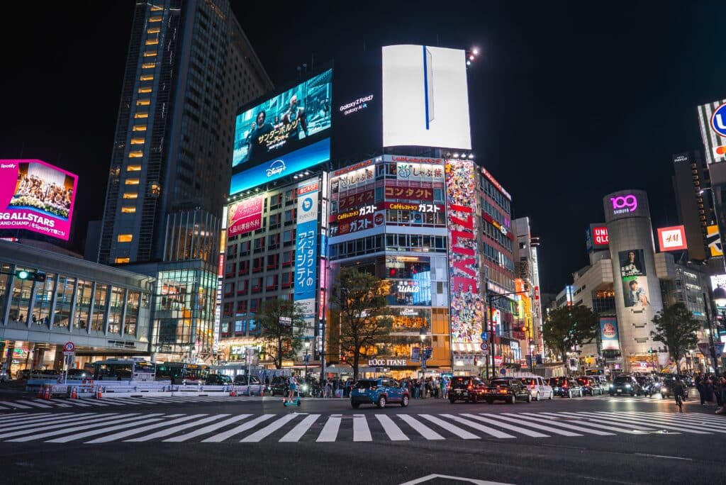 Shibuya district in Tokyo illuminated by billboards and city lights at night
