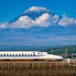 Shinkansen bullet train passing Mount Fuji in Japan