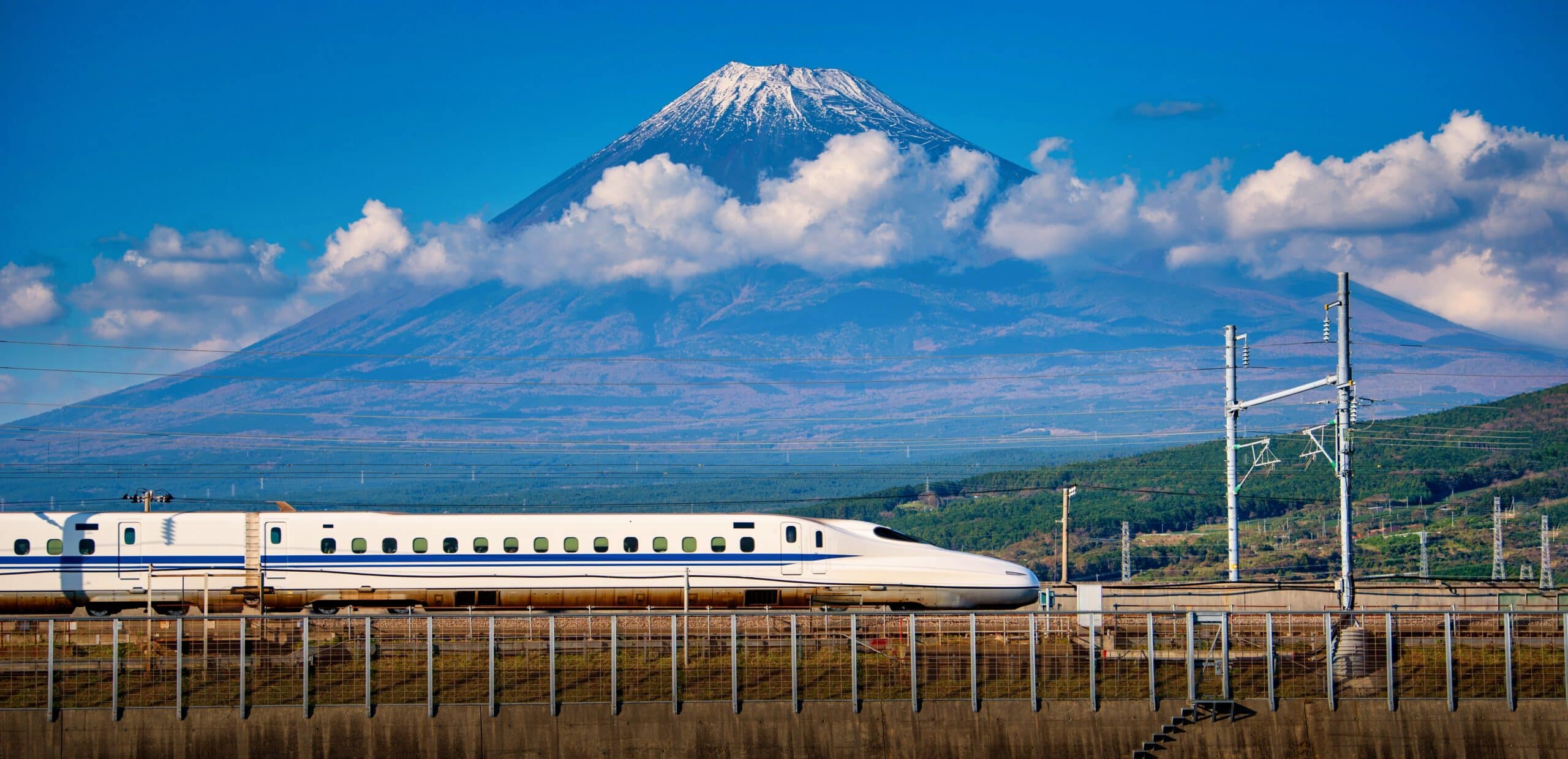 Shinkansen bullet train passing Mount Fuji in Japan